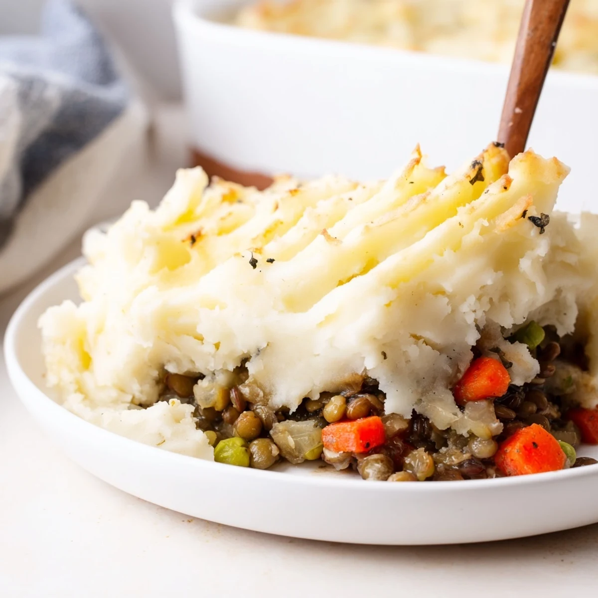 Golden, creamy mashed potatoes top a savory Hearty Lentil Shepherds Pie, perfect for a cozy dinner.