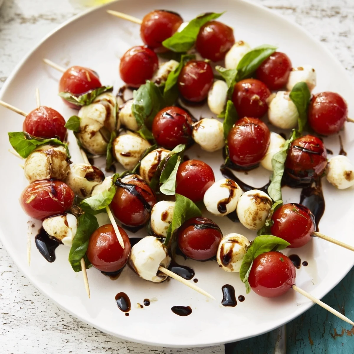 Fresh Caprese Salad Skewers: colorful bites with juicy tomatoes, basil, and creamy mozzarella, drizzled with balsamic.