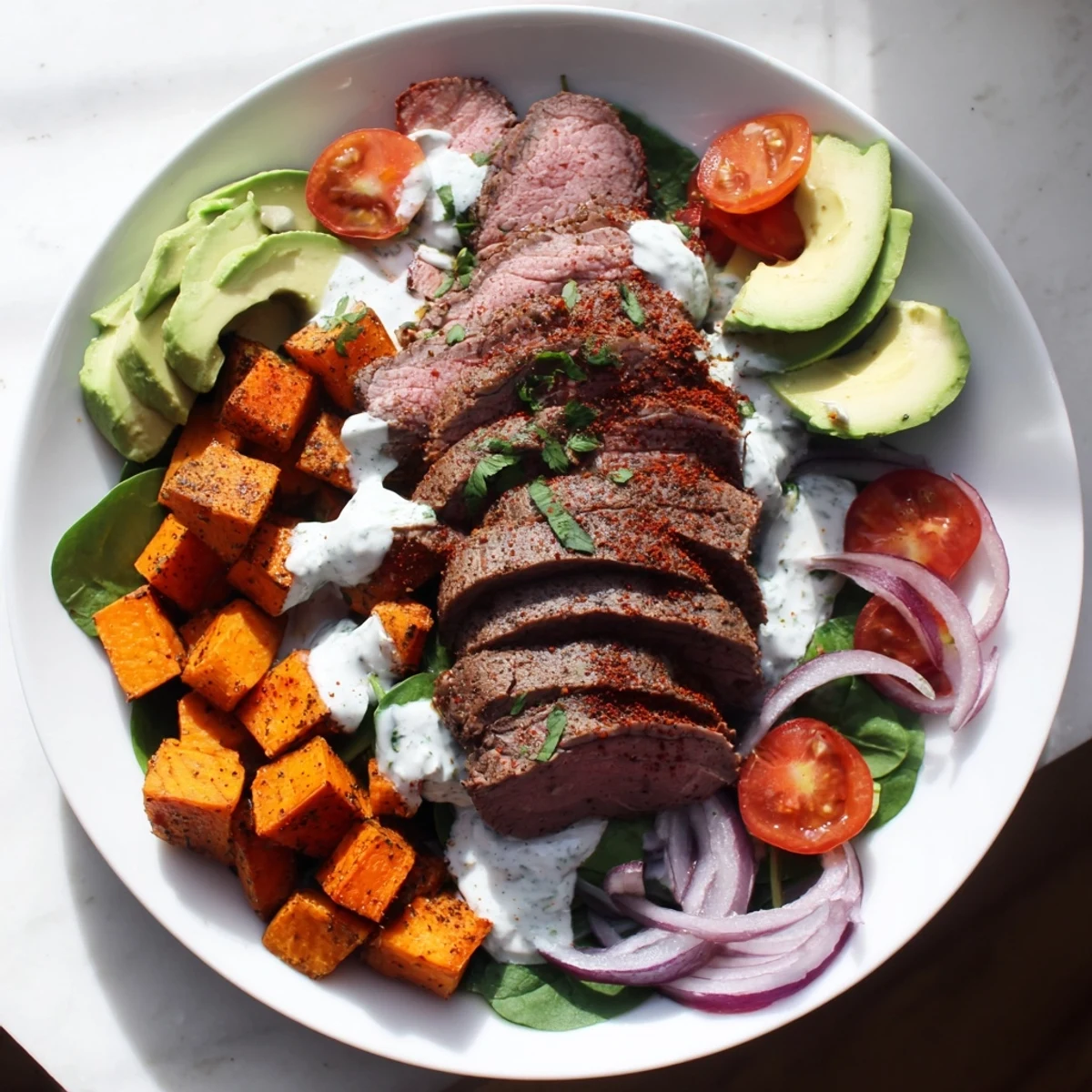 Close-up of a delicious Beef Avocado Sweet Potato Bowl, showcasing tender beef and fresh, colorful toppings.