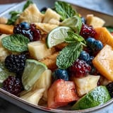 A colorful tropical fruit platter featuring ripe mangoes and juicy pineapple slices arranged for a summer party.