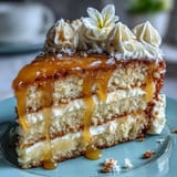 Bright yellow lemon curd cake finished with fluffy whipped cream and vibrant edible blooms.