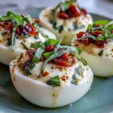 Plated Caprese deviled eggs, bursting with basil flavor and Italian antipasto charm.
