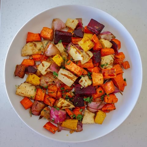 Oven-roasted root vegetable medley glistening with balsamic glaze, a colorful, hearty vegetarian meal.