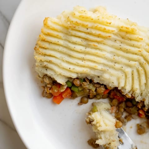 Warm, inviting image of Hearty Lentil Shepherds Pie, showcasing the tender lentils and vegetable filling.