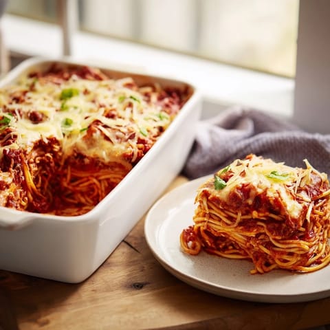 Perfectly baked, creamy Tinis Baked Spaghetti with a layer of delicious, savory ground beef.