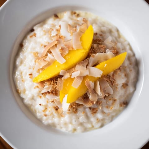 Enjoy a warm bowl of fragrant Toasted Coconut Rice Pudding, a comforting dessert or breakfast.