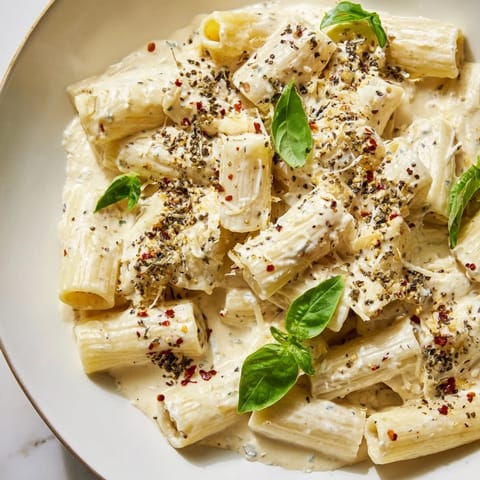 A close-up shot of Creamy Cottage Cheese Pasta, showing a creamy, lightly peppered sauce coating the pasta.