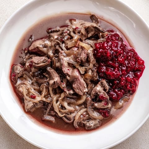 Warm, hearty close-up showing slow-cooked Finnish Reindeer Stew, flavorful and slightly creamy.