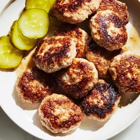 Juicy and savory Danish Frikadeller, perfectly fried, offering a delicious traditional Danish pork meatball meal idea.
