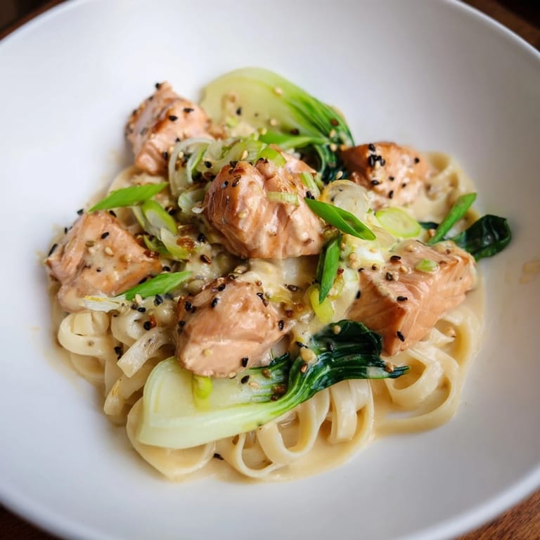 Tender salmon pieces coat linguine in rich miso butter sauce, a flavorful miso butter salmon pasta dinner.