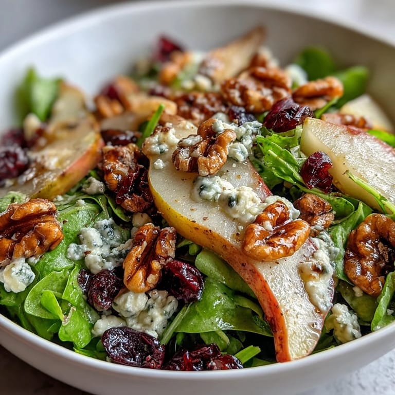 Fresh Pear Gorgonzola Salad photo featuring creamy cheese, ripe fruit, and toasted nuts.